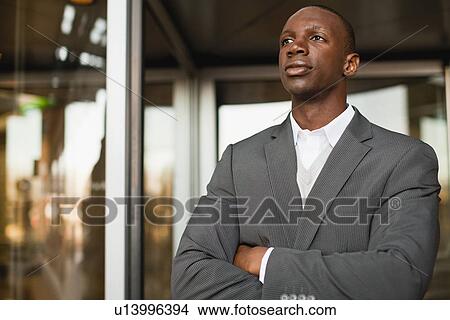 Businessman standing outside building View Large Photo Image Picture - Businessman standing outside building. Fotosearch