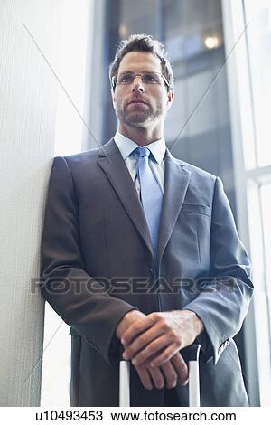 Businessman standing with hands folded View Large Photo Image Stock Image - Businessman standing with hands folded. Fotosearch