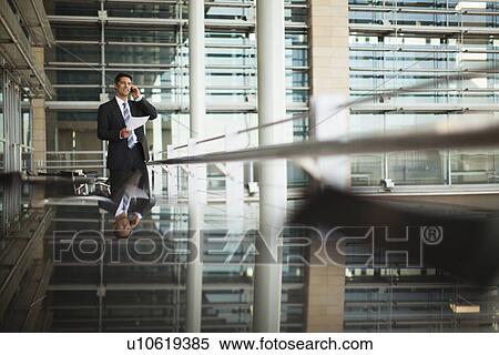 Businessman talking on cell phone View Large Photo Image Stock Photography - Businessman talking on cell phone. Fotosearch