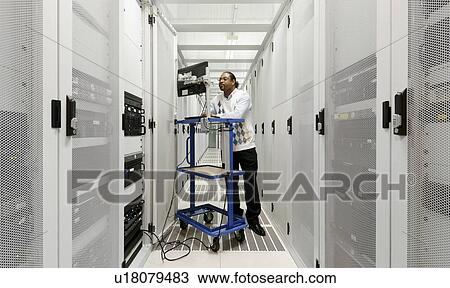 Businessman using computer with servers View Large Photo Image Stock Image - Businessman using computer with servers. Fotosearch