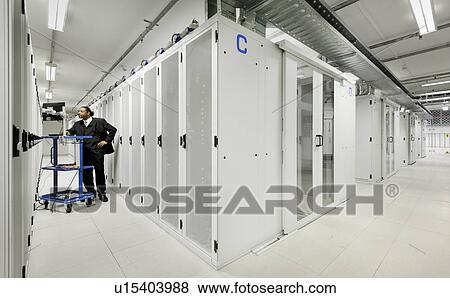 Businessman using computer with servers View Large Photo Image Stock Photo - Businessman using computer with servers. Fotosearch