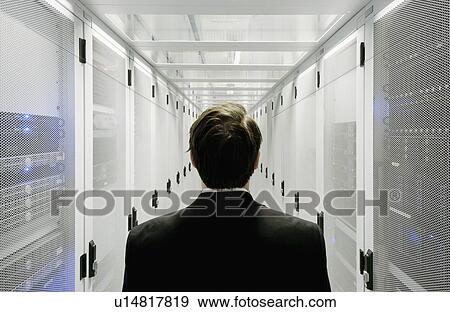 Businessman walking in server room View Large Photo Image Stock Photo - Businessman walking in server room. Fotosearch