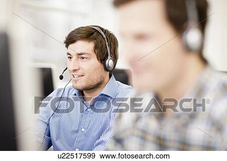 Businessman working in headset View Large Photo Image Stock Photo - Businessman working in headset. Fotosearch