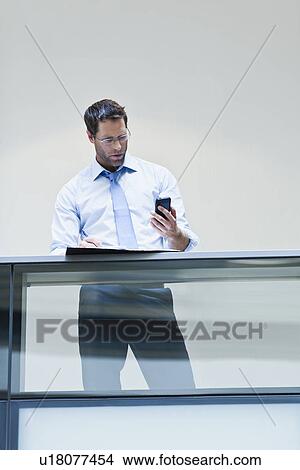 Picture - Businessman working on balcony. Fotosearch