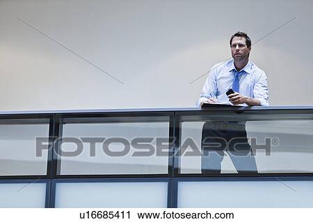 Businessman working on balcony View Large Photo Image Stock Image - Businessman working on balcony. Fotosearch