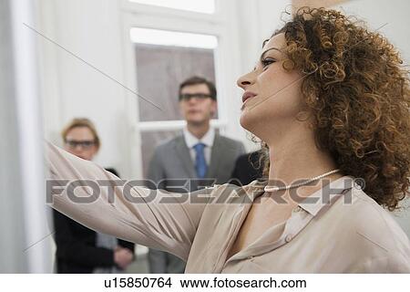 Businesswoman drawing on board View Large Photo Image Picture - Businesswoman drawing on board. Fotosearch