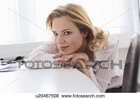 Businesswoman resting chin in hands View Large Photo Image Stock Photo - Businesswoman resting chin in hands. Fotosearch