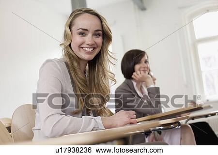 Stock Photograph - Businesswoman smiling at desk. Fotosearch