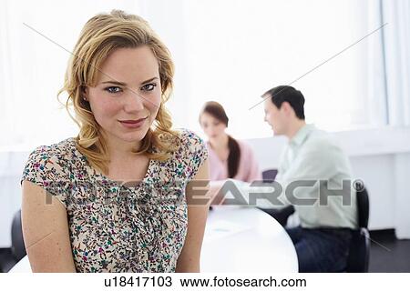 Businesswoman smiling in office View Large Photo Image Stock Image - Businesswoman smiling in office. Fotosearch