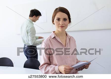 Businesswoman smiling in office View Large Photo Image Stock Image - Businesswoman smiling in office. Fotosearch