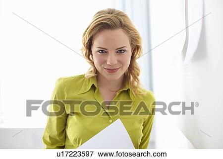 Businesswoman smiling in office View Large Photo Image Stock Photo - Businesswoman smiling in office. Fotosearch