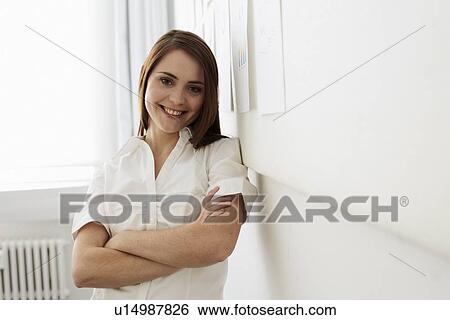 Businesswoman smiling in office View Large Photo Image Stock Photograph - Businesswoman smiling in office. Fotosearch