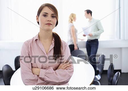 Businesswoman standing in office View Large Photo Image Stock Photograph - Businesswoman standing in office. Fotosearch