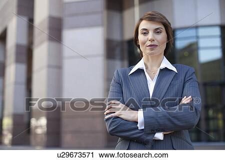 Businesswoman standing with arms crossed View Large Photo Image Stock Image - Businesswoman standing with arms crossed. Fotosearch
