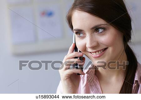 Picture - Businesswoman talking on cell phone. Fotosearch