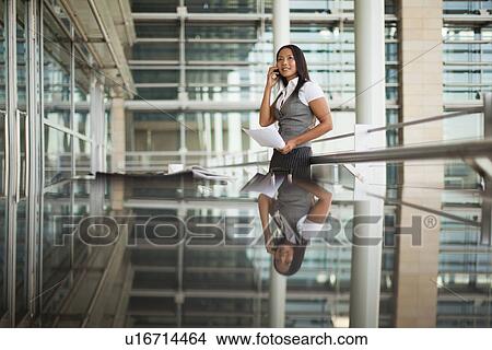 Picture - Businesswoman talking on cell phone. Fotosearch