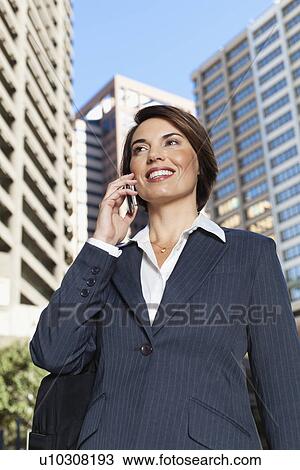 Businesswoman talking on cell phone View Large Photo Image Stock Image - Businesswoman talking on cell phone. Fotosearch