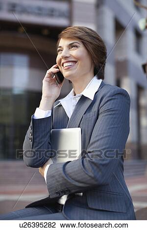 Businesswoman talking on cell phone View Large Photo Image Stock Image - Businesswoman talking on cell phone. Fotosearch