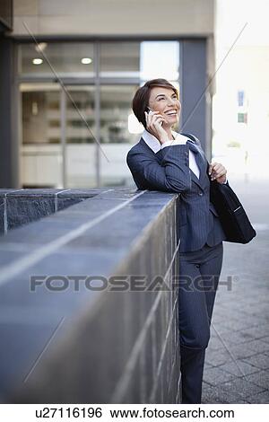 Businesswoman talking on cell phone View Large Photo Image Stock Photograph - Businesswoman talking on cell phone. Fotosearch