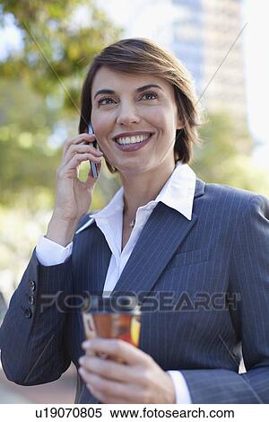Businesswoman talking on cell phone View Large Photo Image Stock Photography - Businesswoman talking on cell phone. Fotosearch
