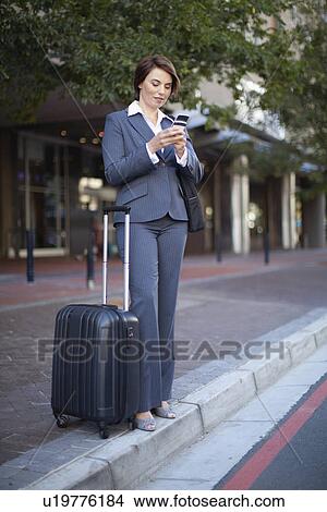 Businesswoman using cell phone outdoors View Large Photo Image Picture - Businesswoman using cell phone outdoors. Fotosearch