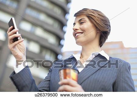 Businesswoman using cell phone outdoors View Large Photo Image Stock Image - Businesswoman using cell phone outdoors. Fotosearch