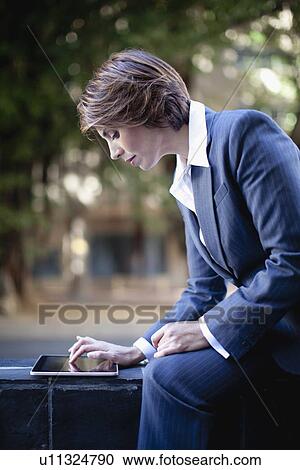 Businesswoman using tablet computer View Large Photo Image Stock Image - Businesswoman using tablet computer. Fotosearch