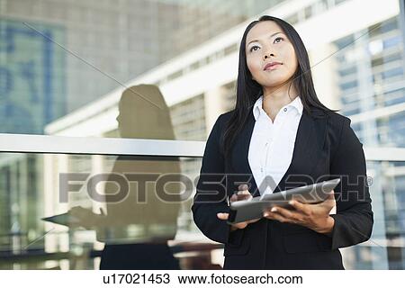 Businesswoman using tablet computer View Large Photo Image Stock Image - Businesswoman using tablet computer. Fotosearch