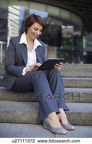 Stock Image - Businesswoman using tablet computer. Fotosearch