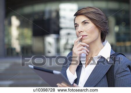Businesswoman using tablet computer View Large Photo Image Stock Photo - Businesswoman using tablet computer. Fotosearch