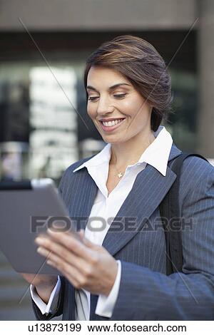 Businesswoman using tablet computer View Large Photo Image Stock Photo - Businesswoman using tablet computer. Fotosearch