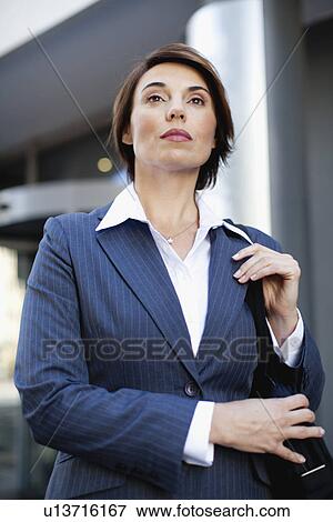 Businesswoman walking on city street View Large Photo Image Stock Photo - Businesswoman walking on city street. Fotosearch