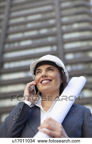 Businesswoman with blueprints outdoors View Large Photo Image Picture - Businesswoman with blueprints outdoors. Fotosearch