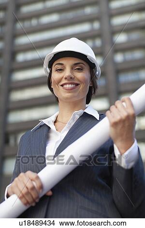 Businesswoman with blueprints outdoors View Large Photo Image Picture - Businesswoman with blueprints outdoors. Fotosearch