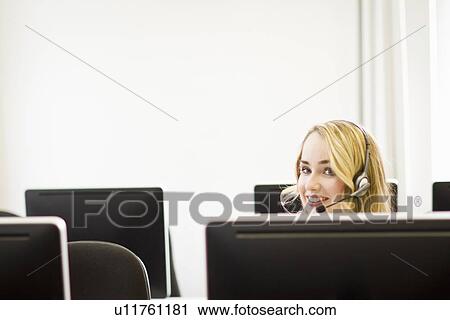 Businesswoman working in headset View Large Photo Image Stock Image - Businesswoman working in headset. Fotosearch