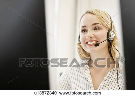 Businesswoman working in headset View Large Photo Image Stock Image - Businesswoman working in headset. Fotosearch