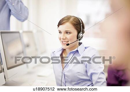 Businesswoman working in headset View Large Photo Image Stock Image - Businesswoman working in headset. Fotosearch