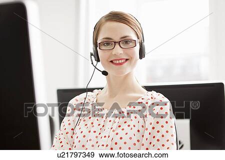 Businesswoman working in headset View Large Photo Image Stock Photo - Businesswoman working in headset. Fotosearch