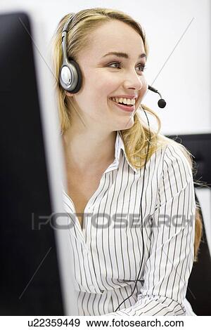 Stock Photo - Businesswoman working in headset. Fotosearch
