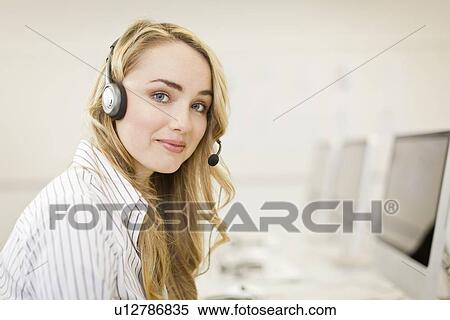 Stock Photography - Businesswoman working in headset. Fotosearch