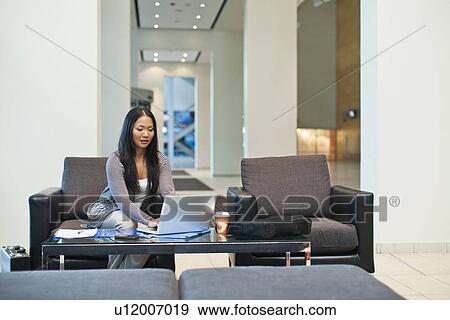 Businesswoman working in lobby View Large Photo Image Stock Photo - Businesswoman working in lobby. Fotosearch