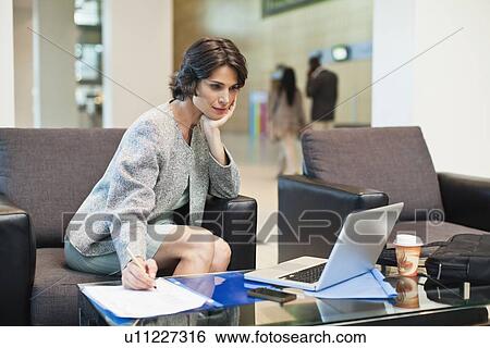 Businesswoman working in lobby View Large Photo Image Stock Photograph - Businesswoman working in lobby. Fotosearch