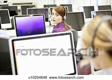 Stock Photo - Businesswomen working in headsets. Fotosearch