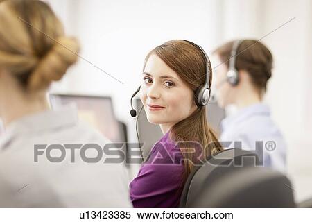 Stock Photography - Businesswomen working in headsets. Fotosearch