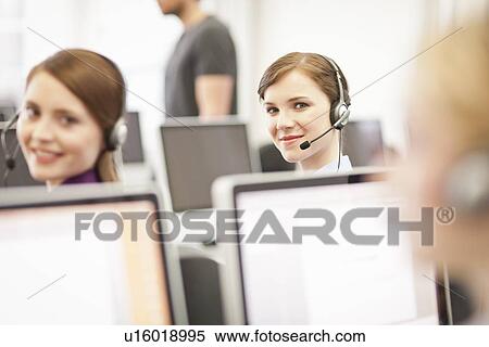 Businesswomen working in headsets View Large Photo Image Stock Photography - Businesswomen working in headsets. Fotosearch