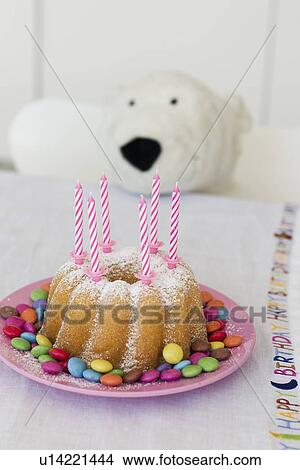 Candles in decorated birthday cake View Large Photo Image Picture - Candles in decorated birthday cake. Fotosearch