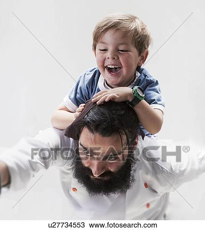 Chef carrying son on his back View Large Photo Image Stock Image - Chef carrying son on his back. Fotosearch
