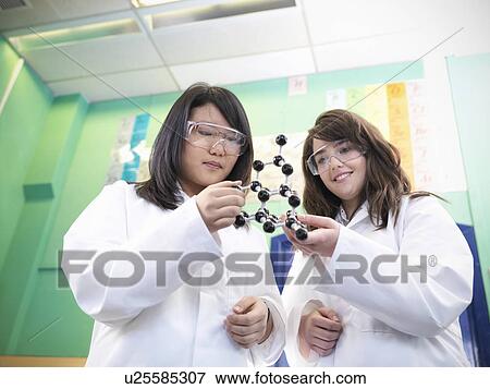 Stock Photo - Chemistry students examining models. Fotosearch