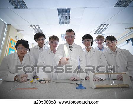 Chemistry teacher and students in lab View Large Photo Image Stock Photo - Chemistry teacher and students in lab. Fotosearch