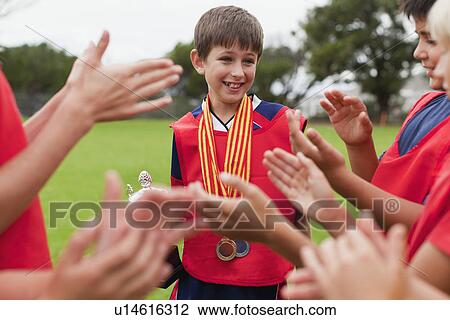 Children cheering teammate with trophy View Large Photo Image Stock Image - Children cheering teammate with trophy. Fotosearch